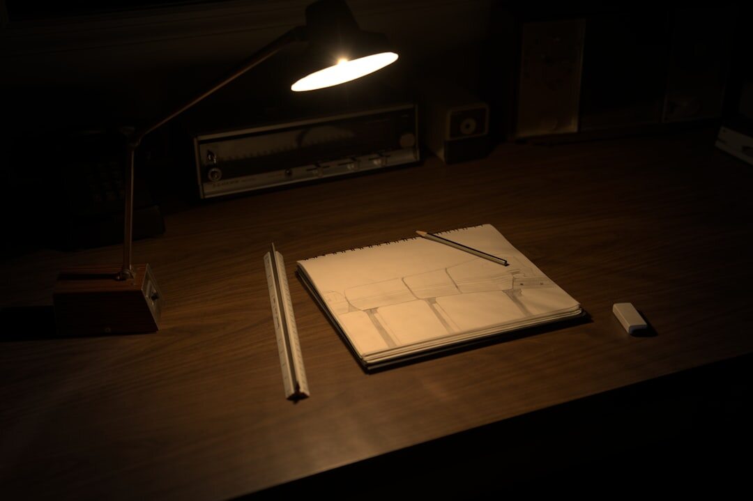 Vintage typewriter with a sheet of paper under a desk lamp