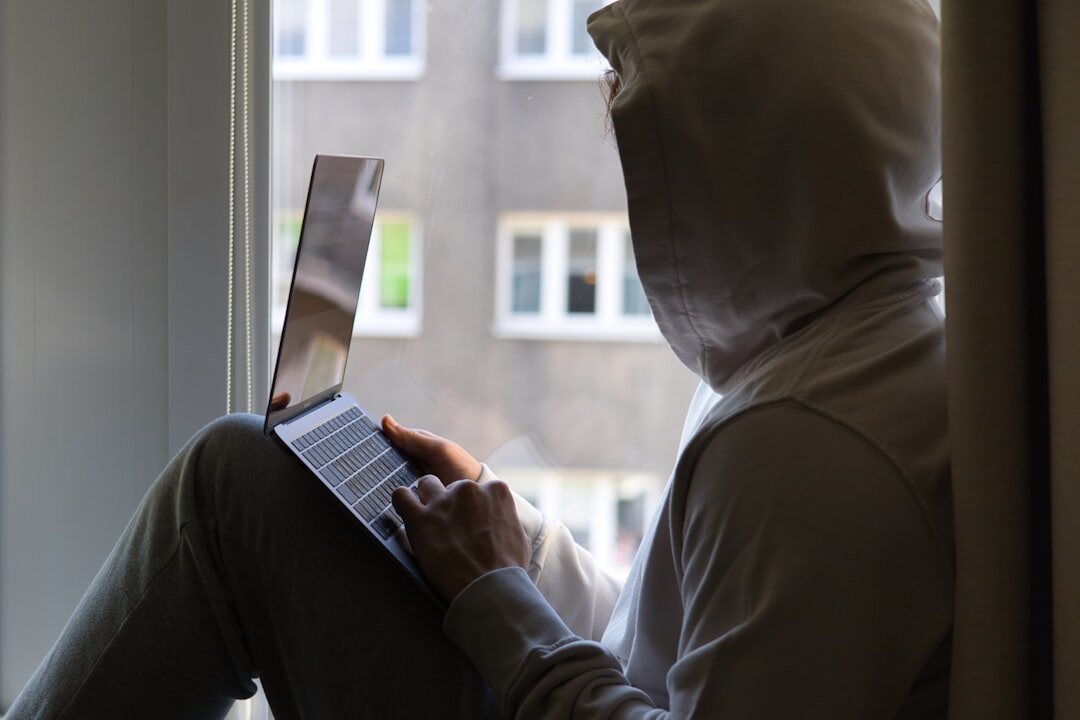 person reading mystery book by window